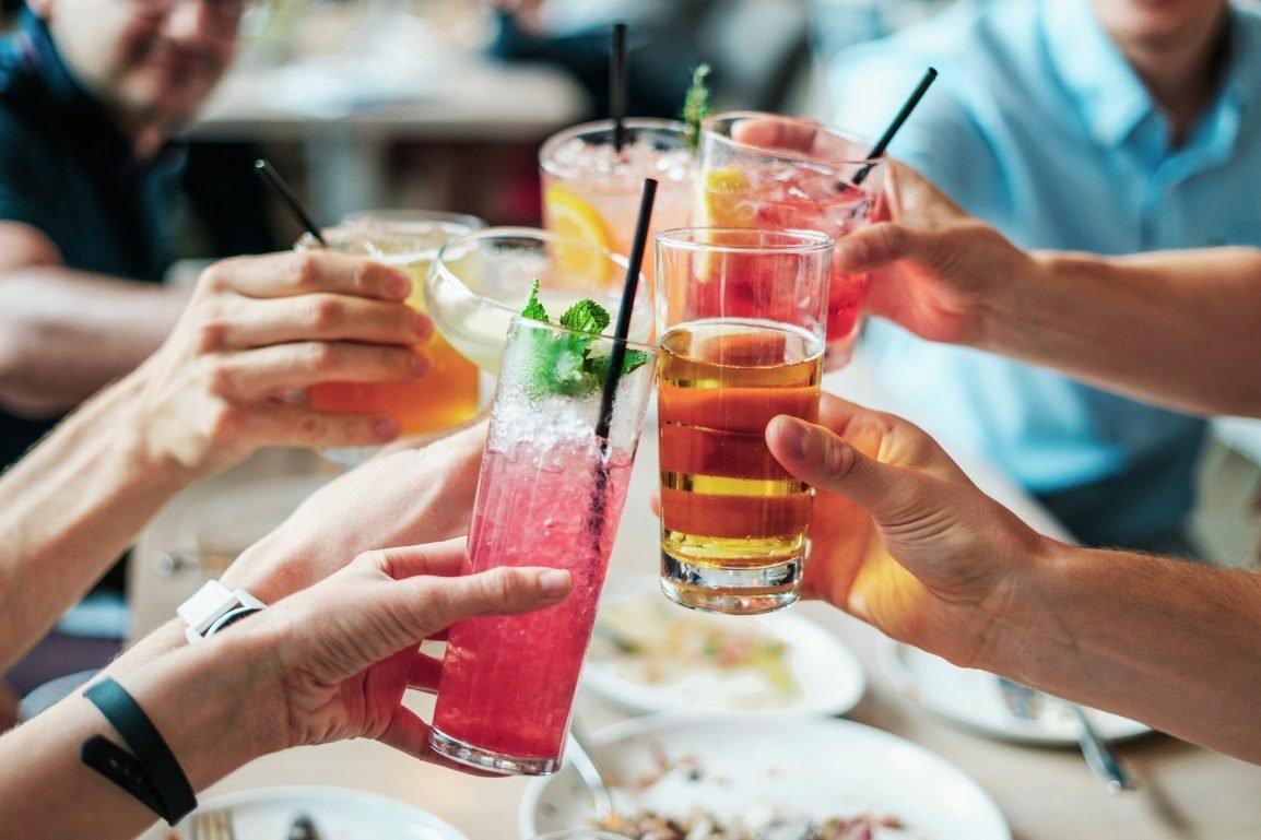 An image of 6 people toasting their adult beverages. Symbolizing Teen Alcohol Addiction.