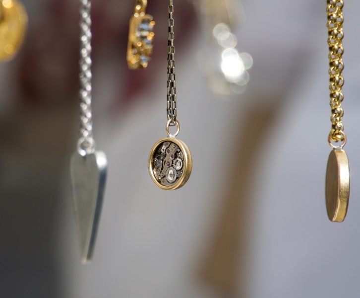 various colored and styles of necklaces hanging in a row